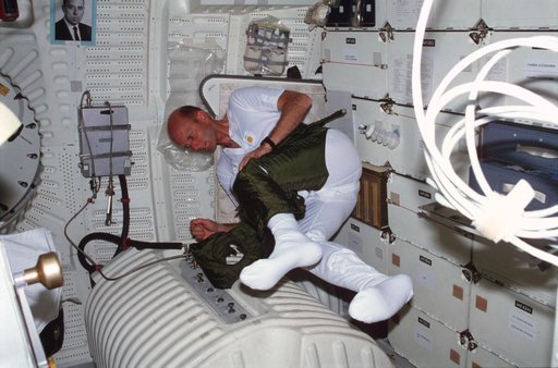 Pilot Fullerton dons EES anti-gravity suit lower torso on middeck