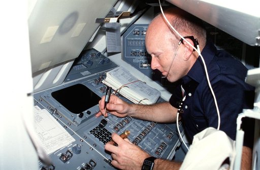 Pilot Fullerton repairs keyboard on Aft Flight Deck control panel R12L
