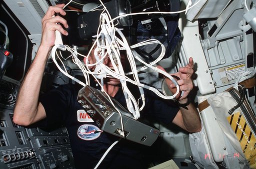 Commander Mattingly tangles with NOSL experiment on aft flight deck