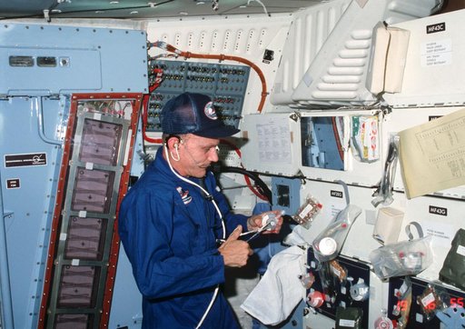 Commander Mattingly prepares meal on middeck