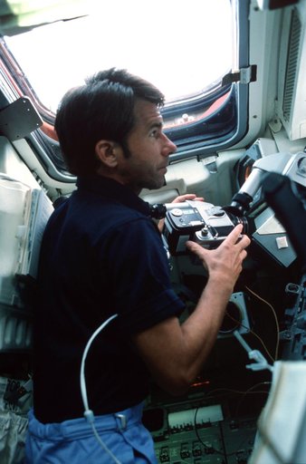 Mission Specialist (MS) Lenoir at aft flight deck with HASSELBLAD camera