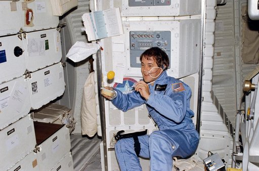 Mission Specialist (MS) Allen experiments with beverage on middeck