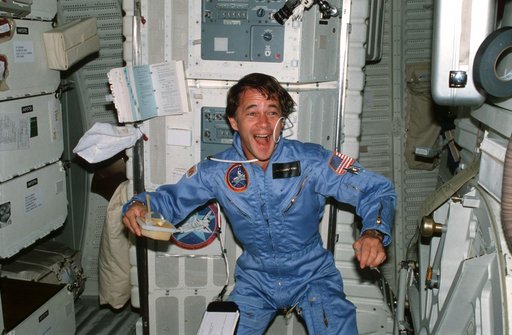 Mission Specialist (MS) Allen experiments with beverage on middeck