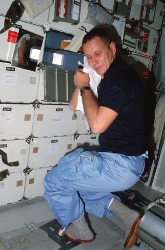 Pilot Overmyer completes hygiene activities / demostrates IVA foot restraint