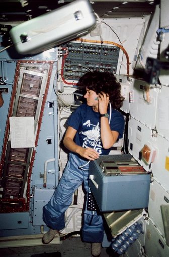 Mission Specialist (MS) Ride adjusts headset (HDST) on middeck