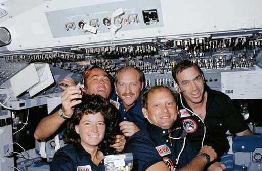 Crew members pose for group portrait on forward flight deck