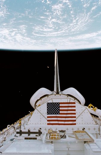 PLB, vertical tail, OMS pods above Earth with moon in distant background