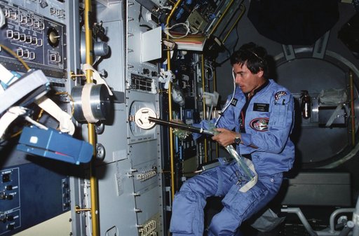 Payload specialist Merbold performing experiment in Spacelab