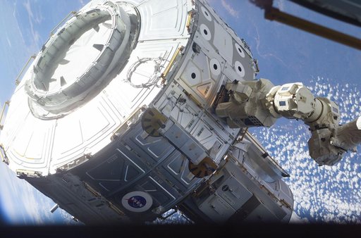 Quest airlock maneuvered into position
