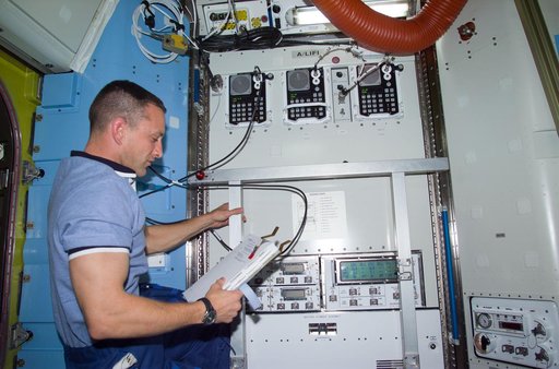 PLT Horbaugh at control panel in Quest airlock