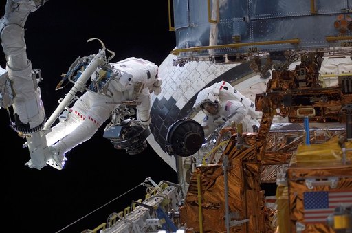 STS-109 MS Massimino and Newman replace Reaction Wheel assembly during EVA 2