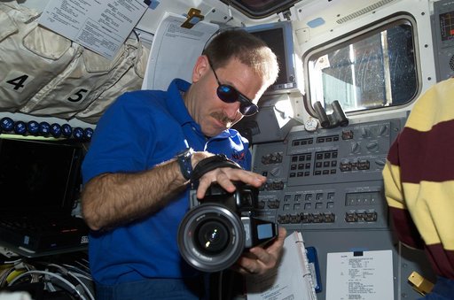 MS Grunsfeld on flight deck with video camera