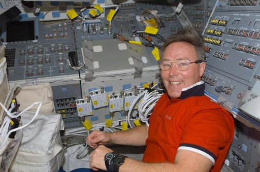 MS Ross poses on the flight deck of Atlantis during STS-110