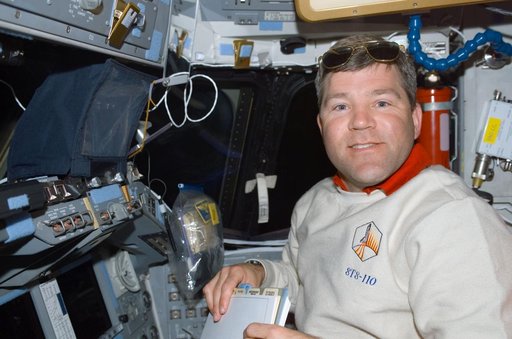 Pilot Frick works at the pilot's workstation on the flight deck of Atlantis during STS-110