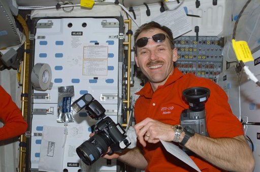 MS Smith poses with cameras on the middeck of Atlantis during STS-110
