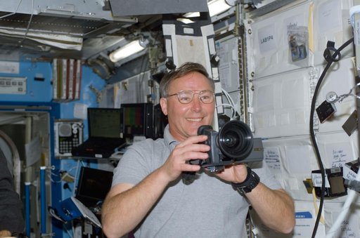 Ross uses a video camera in Destiny during STS-110's initial ingress into the ISS