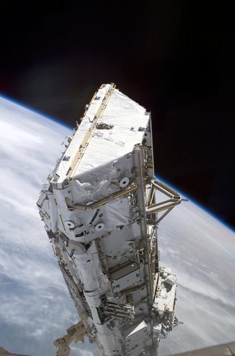 View of the S0 Truss being moved into installation position by the SSRMS during STS-110