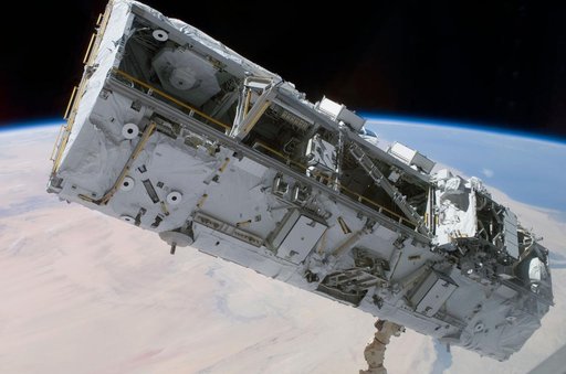 View of the S0 Truss being moved into installation position by the SSRMS during STS-110