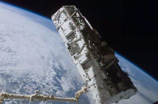View of the S0 Truss being moved into installation position by the SSRMS during STS-110