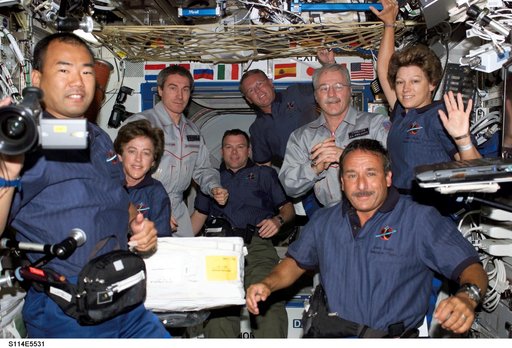 STS-114 and Expedition 11 crew gathered in the Destiny laboratory module