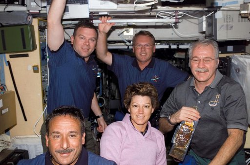 STS-114 and Expedition 11 crew pose for a photo in Zvezda Service module