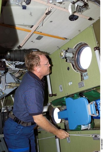 Thomas looks through Zvezda window