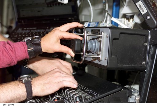 Lawrence and Kelly's hands on controls in the Destiny laboratory module