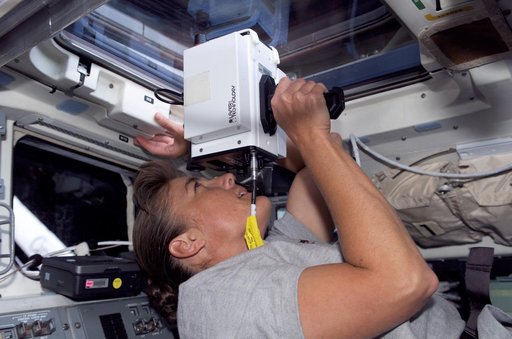 STS-115 MS Stefanyshyn-Piper uses laser ranging device throught window in the Aft FD