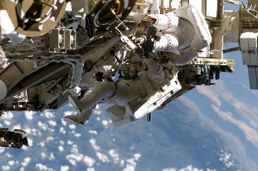 STS-115 MS Burbank and MacLean prepare the SARJ on the P3 - P4 Truss Segment during EVA