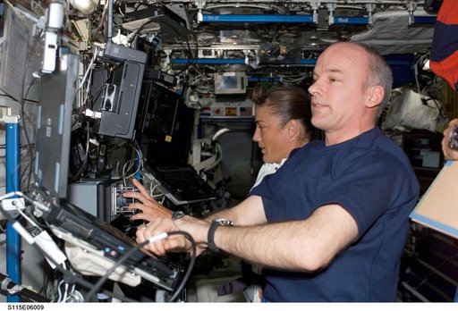 Expedition 13 Commander Williams and STS-115 MS Stefanyshyn-Piper work at the SSRMS in the U.S. Laboratory