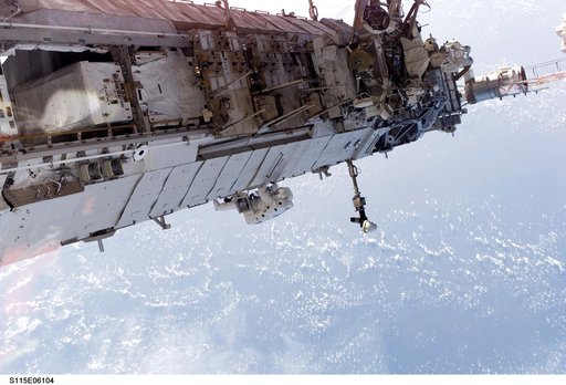 STS-115 MS Stefanyshyn-Piper releases PVR cinches and winch PIP pins on the P3/P4 Truss during EVA