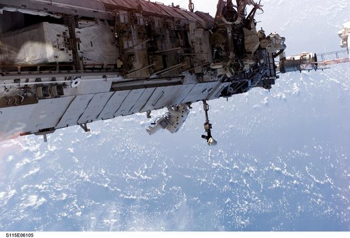 STS-115 MS Stefanyshyn-Piper releases PVR cinches and winch PIP pins on the P3/P4 Truss during EVA