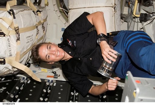 STS-115 MS MacLean holds Yeast GAP in the FWD MDDK of the Space Shuttle Atlantis during Joint Operations