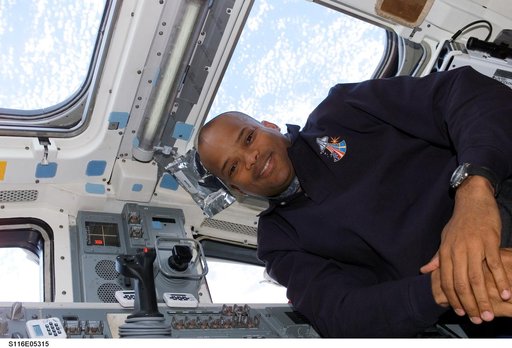 STS-116 MS Curbeam poses in the aft FD on Space Shuttle Discovery