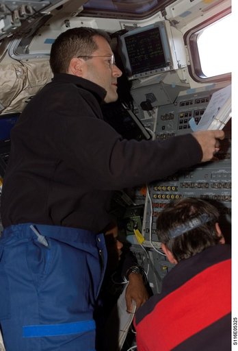 STS-116 MS Patrick looks at crew procedures in the aft FD on Space Shuttle Discovery