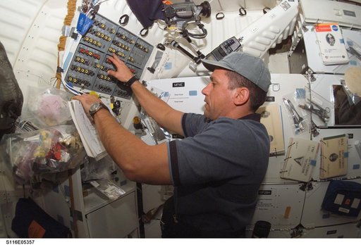 STS-116 MS Patrick works at control panel in the MDDK on Space Shuttle Discovery