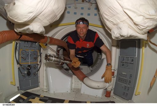 STS-116 MS enters the airlock on Space Shuttle Discovery