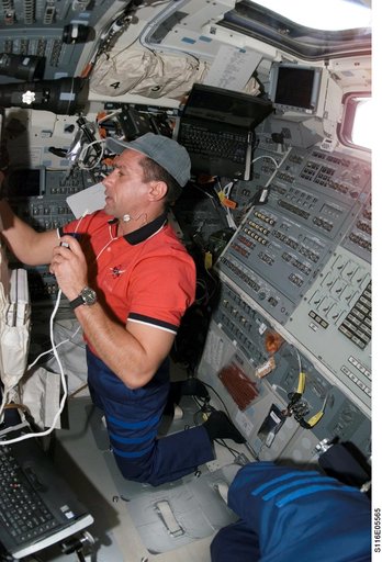 STS-116 Pilot Oefelein uses communication equipment in the aft FD on Space Shuttle Discovery