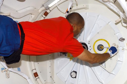 STS-116 MS Curbeam,Jr., prepares to open hatch on Space Shuttle Discovey