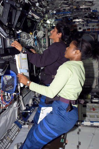 Crewmembers Higginbotham and Williams work at the SSRMS in the U.S. Laboratory during Joint Operations