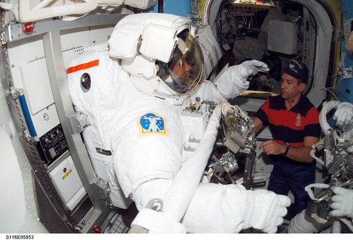 STS-116 MS Fuglesang wearing EMU prepares for EVA in the A/L during Joint Operations
