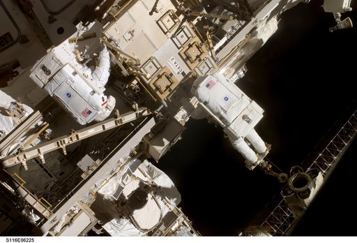 STS-116 MS Fuglesang and Curbeam, Jr., working on CETA 2 cart on EVA 2