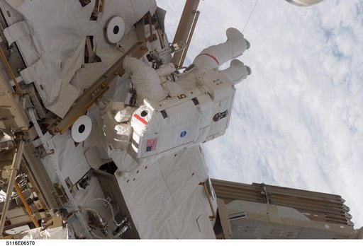 STS-116 MS Curbeam, Jr., works on the S0 and S1 Truss during EVA 3