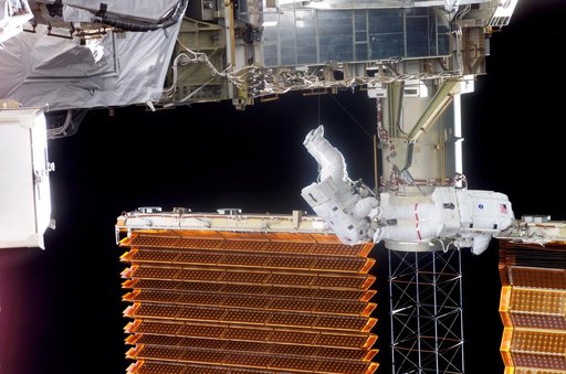 STS-116 Crewmembers Curbeam and Williams work near P6 SAW during EVA 3