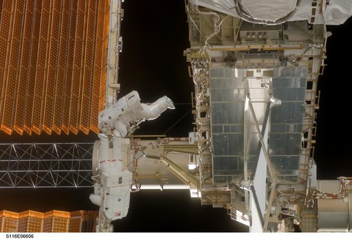 STS-116 Crewmembers Curbeam and Williams work near P6 SAW during EVA 3