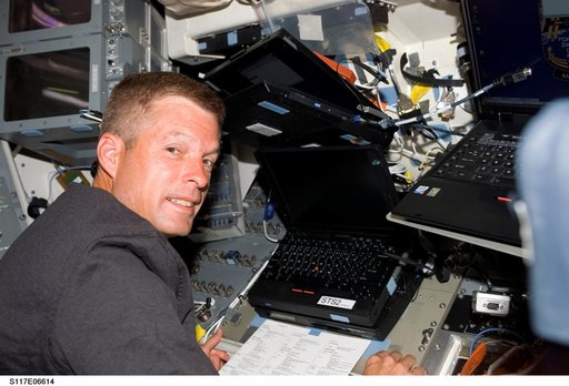 Swanson works at laptop computer on the aft FD of STS-117 Space Shuttle Atlantis