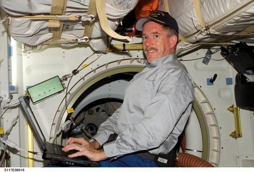 Reilly works at laptop computer in the MDDK on STS-117 Space Shuttle Atlantis