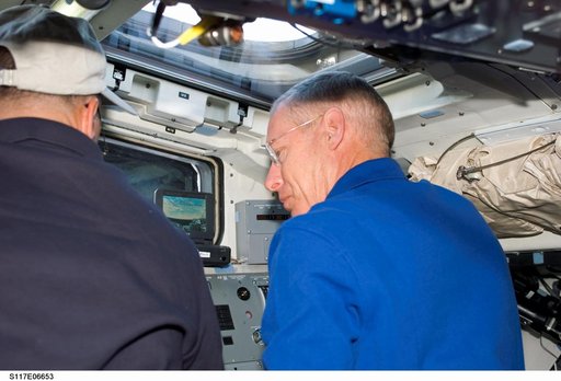 Archambault and Forrester work at control panel on the aft FD of STS-117 Space Shuttle Atlantis