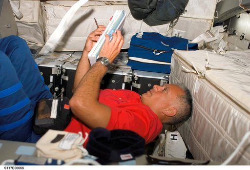 Olivas looks over crew procedures on the MDDK of STS-117 Space Shuttle Atlantis