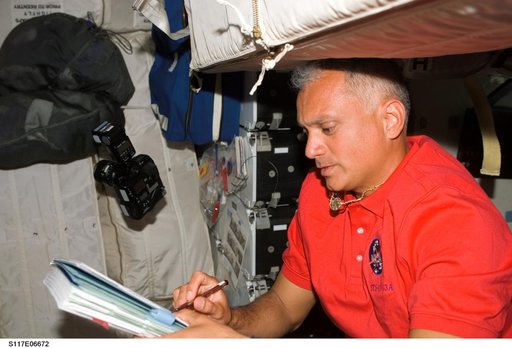 Olivas looks at crew procedures on the MDDK of STS-117 Space Shuttle Atlantis